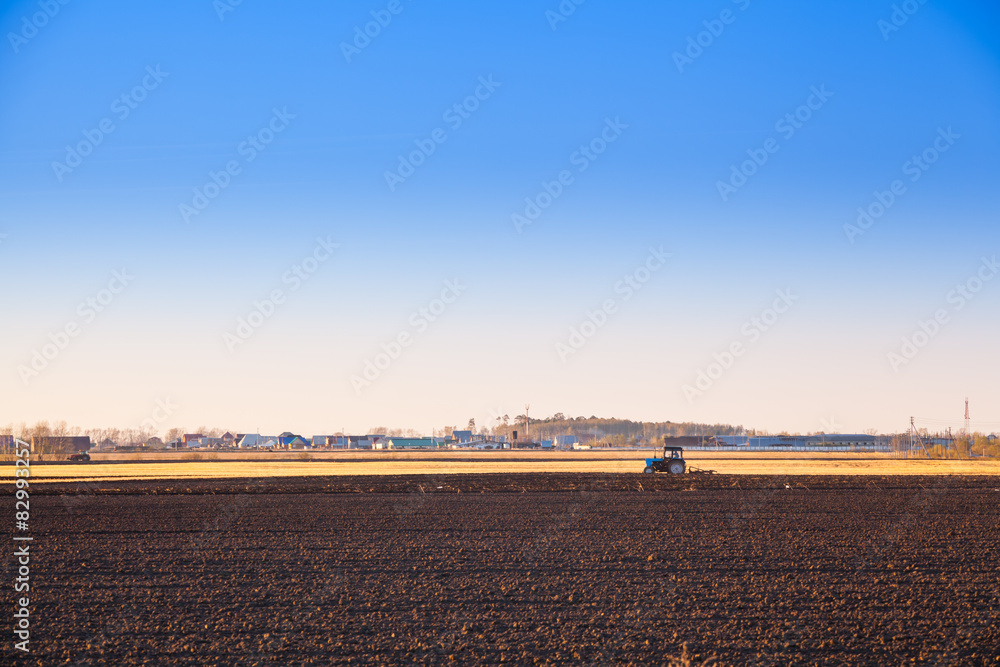 Tractor plowing a field for spring planting