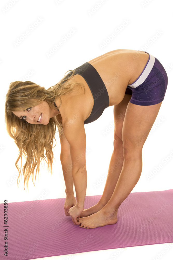 fit woman in purple shorts reach down stretch look fit woman in purple shorts reach down stretch look