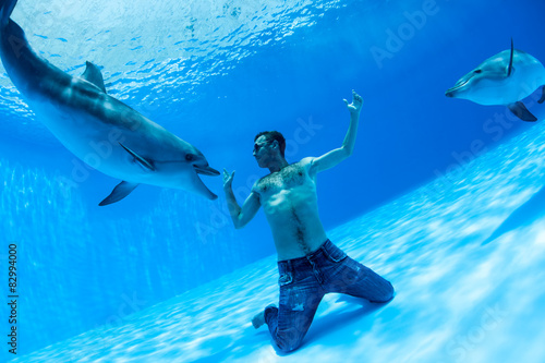 Men and two dolphin