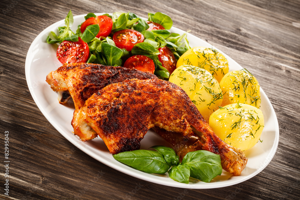 Barbecued chicken legs with boiled potatoes and vegetables Barbecued chicken legs with boiled potatoes and vegetables