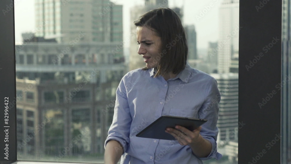 Sad, shocked businesswoman with tablet computer Sad, shocked businesswoman with tablet computer