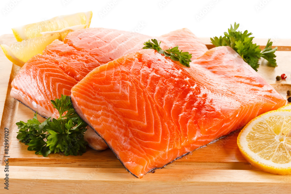 Fresh raw salmon steaks on cutting board Fresh raw salmon steaks on cutting board