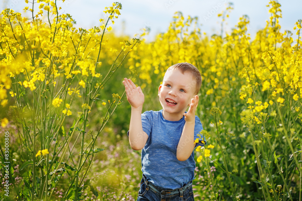 Little boy jumping and clapping and having fun among the bright Little boy jumping and clapping and having fun among the bright
