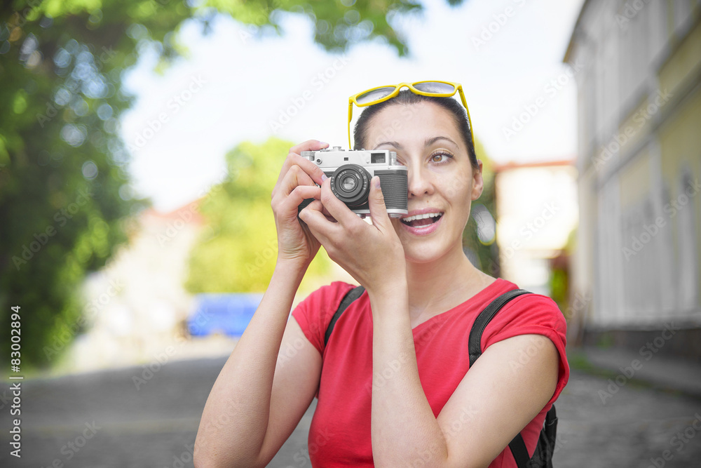 Tourist girl using camera.