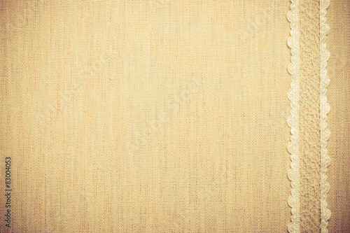 Lace ribbon on linen cloth background