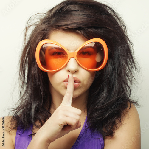 young woman with big orange sunglasses