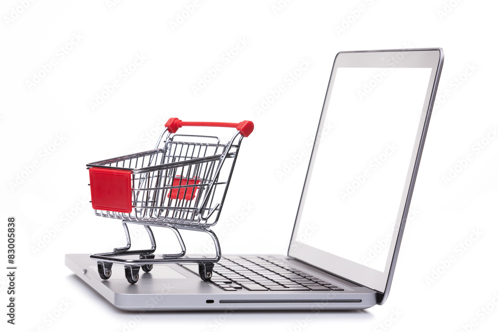 Shopping cart on laptop computer, e-comerce concept Shopping cart on laptop computer, e-comerce concept