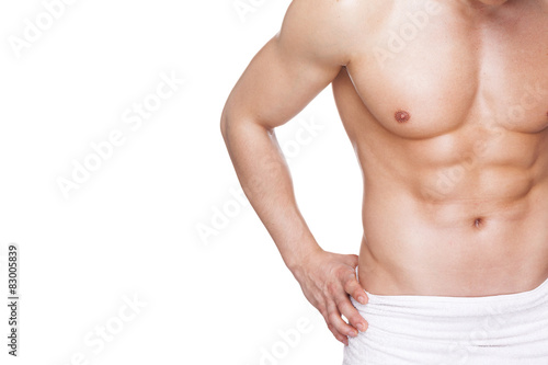 Fit muscular man in towel, isolated on white background