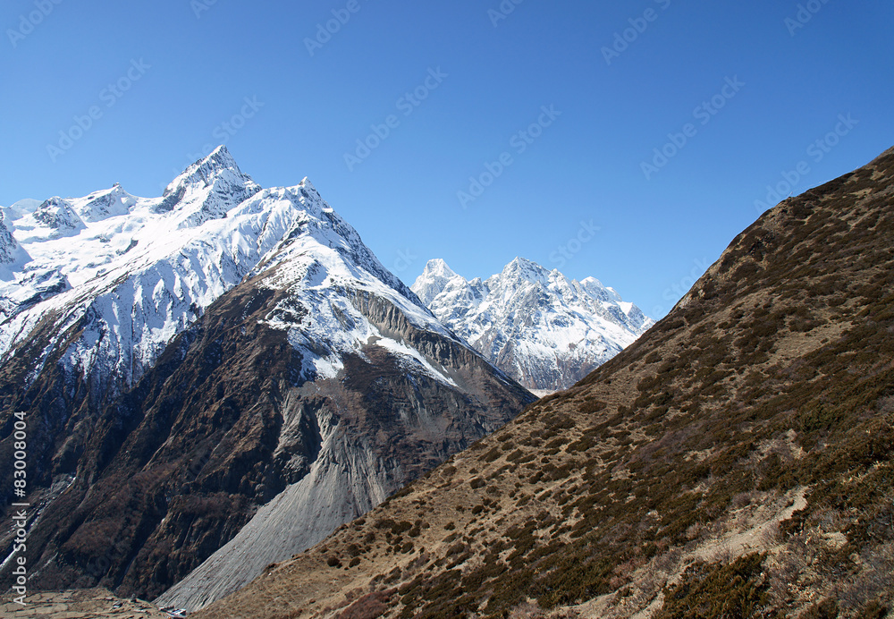 High mountains, snow-capped mountains in a blue sky