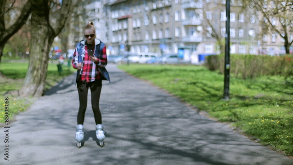 Girl riding on rollerblades and picking up cellphone
Girl riding on rollerblades and picking up cellphone