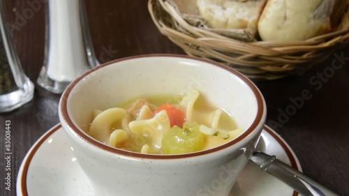 Chicken noodle soup being served
