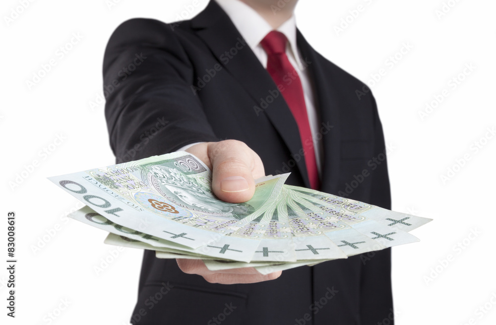 Obraz na plátně Businessman holding polish money. Clipping path included.