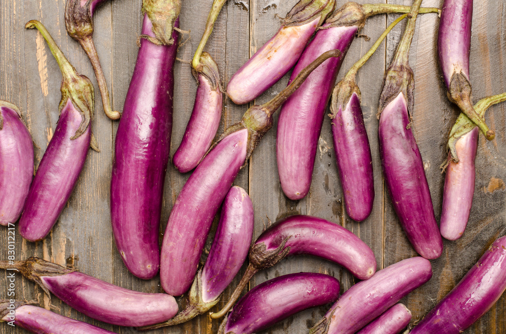 Fresh eggplants on wooden background Fresh eggplants on wooden background