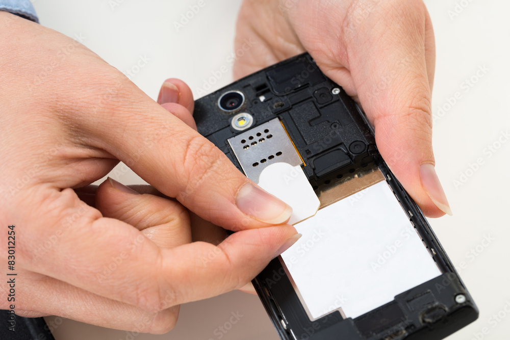 Person Hand With Sim Card And Mobile Phone Person Hand With Sim Card And Mobile Phone