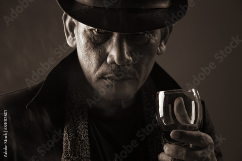 Old gangster and a glass of wine