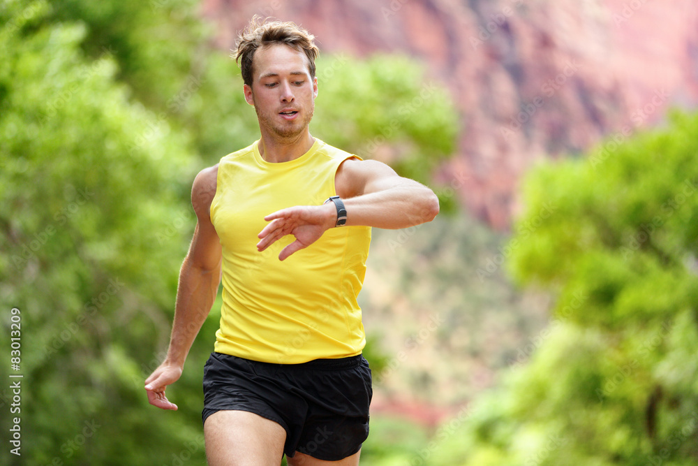 Fototapeta premium Runner looking at heart rate monitor smartwatch