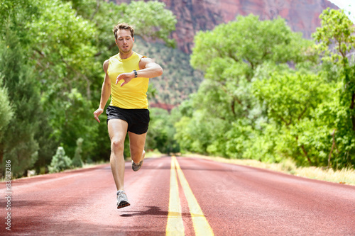 Running man looking heart rate monitor smartwatch © Maridav