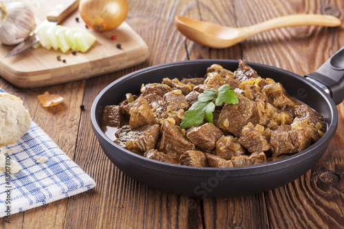 Beef stew - wooden background