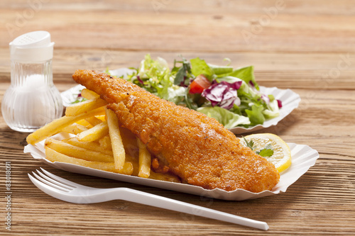 Fried fish and chips on a paper tray photo