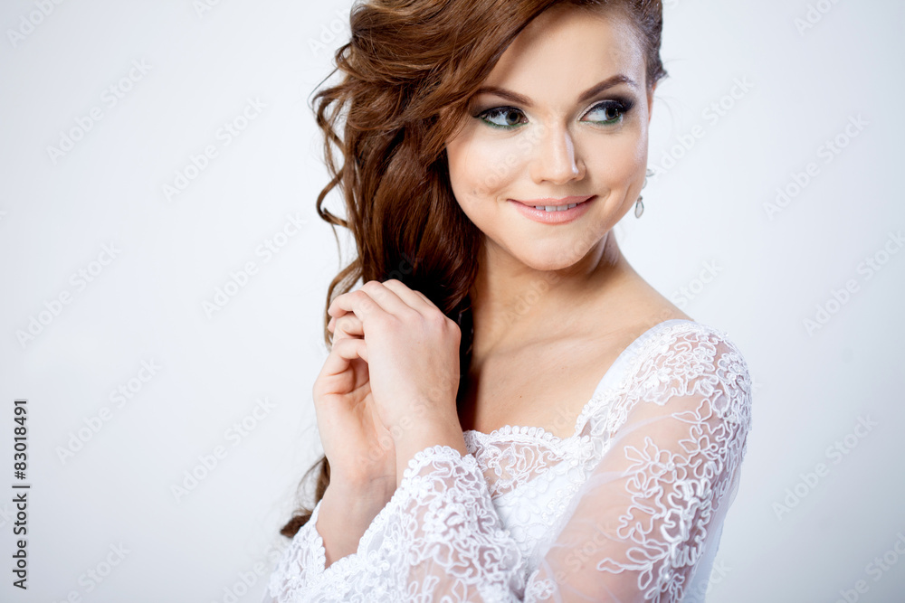 Portrait of happy bride in wedding dress, white background