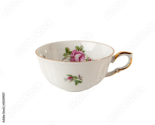 Porcelain teacup with floral rose ornament isolated on white