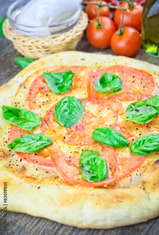 Rustic italian pizza with mozzarella, cheese and basil leaves Rustic italian pizza with mozzarella, cheese and basil leaves
