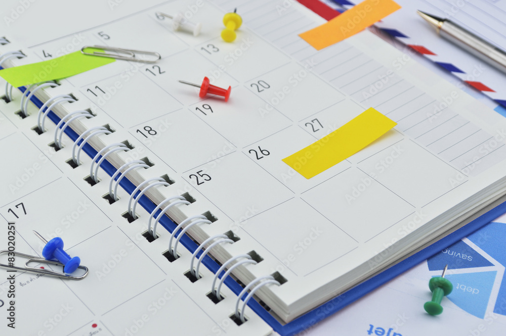 Post It notes with pin and clip on business diary page Post It notes with pin and clip on business diary page