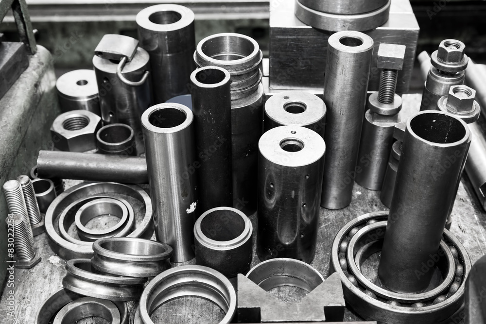 Steel cylinders, pistons and tools in workshop. Industry theme. Steel cylinders, pistons and tools in workshop. Industry theme.