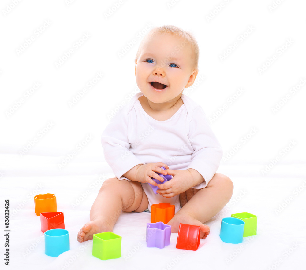 Funny baby sitting playing with colorful toys and laughing Funny baby sitting playing with colorful toys and laughing
