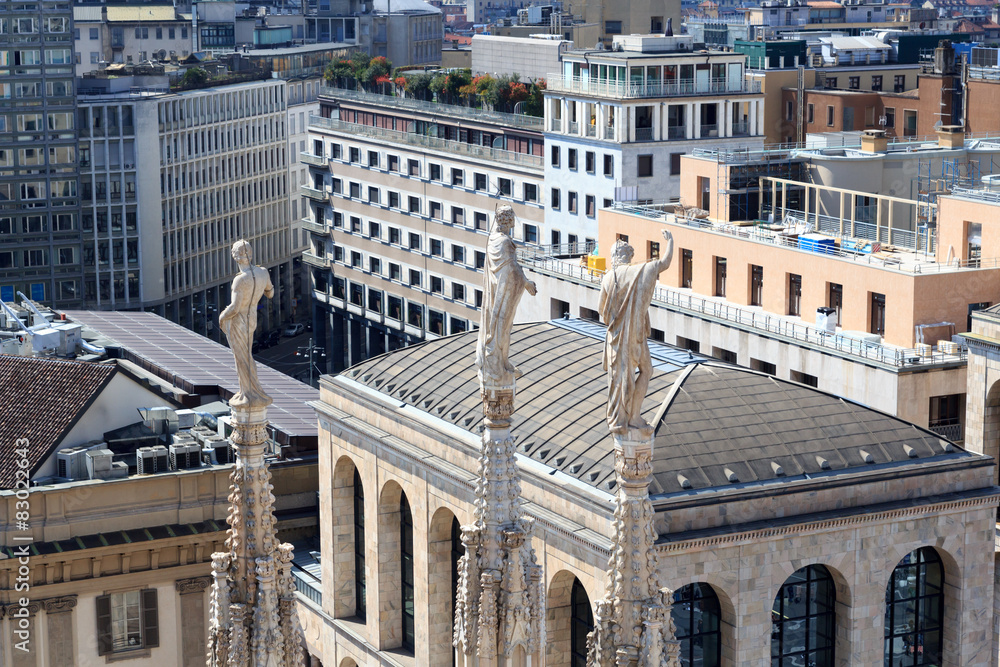 Fototapeta premium Cathedral statue and view of Milan cityscape