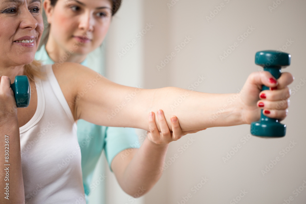 Woman exercising with dumbbells Woman exercising with dumbbells