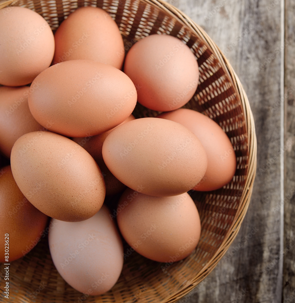 Easter egg in a basket on wodden table