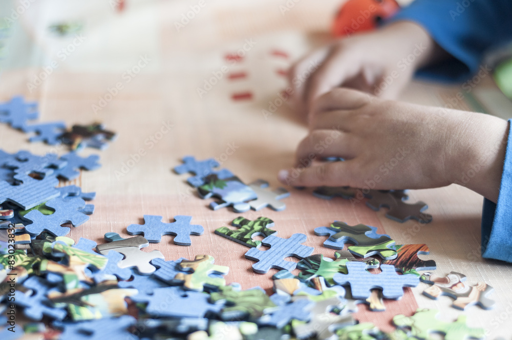hands of a kid making puzzle hands of a kid making puzzle