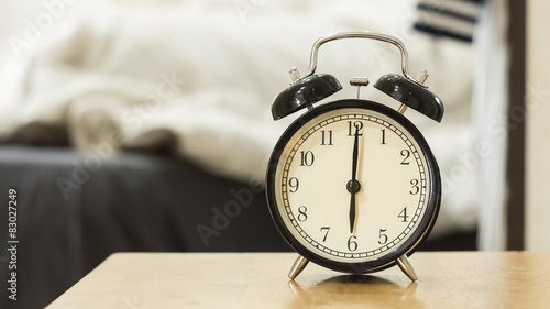 Retro black alarm clock show 6 o'clock in the morning for wake u