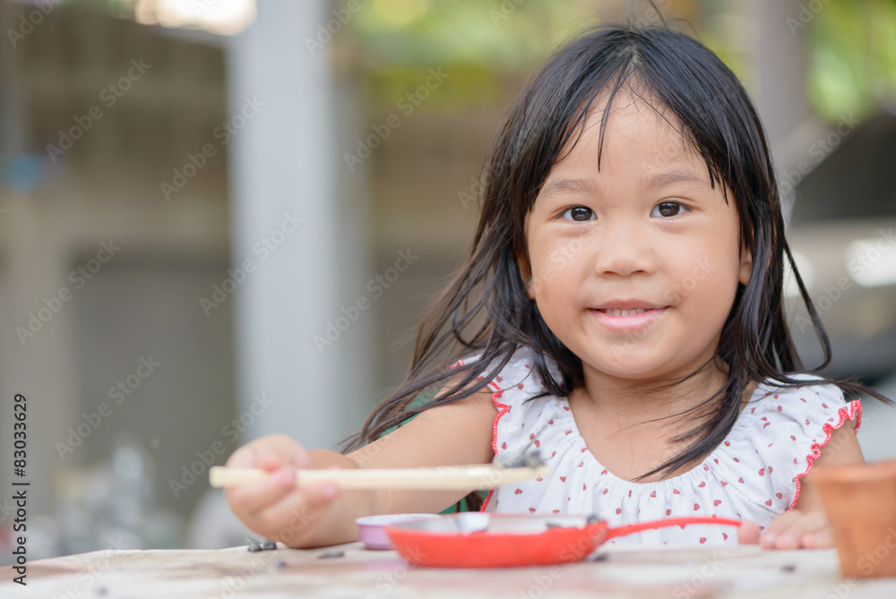 Smiling little girl plays cook on the table Smiling little girl plays cook on the table