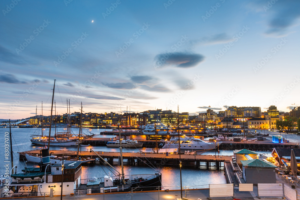 Oslo harbour with boats and yachts at twilight.