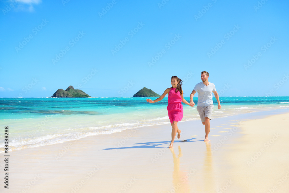 Beach happy couple on running having fun on Hawaii