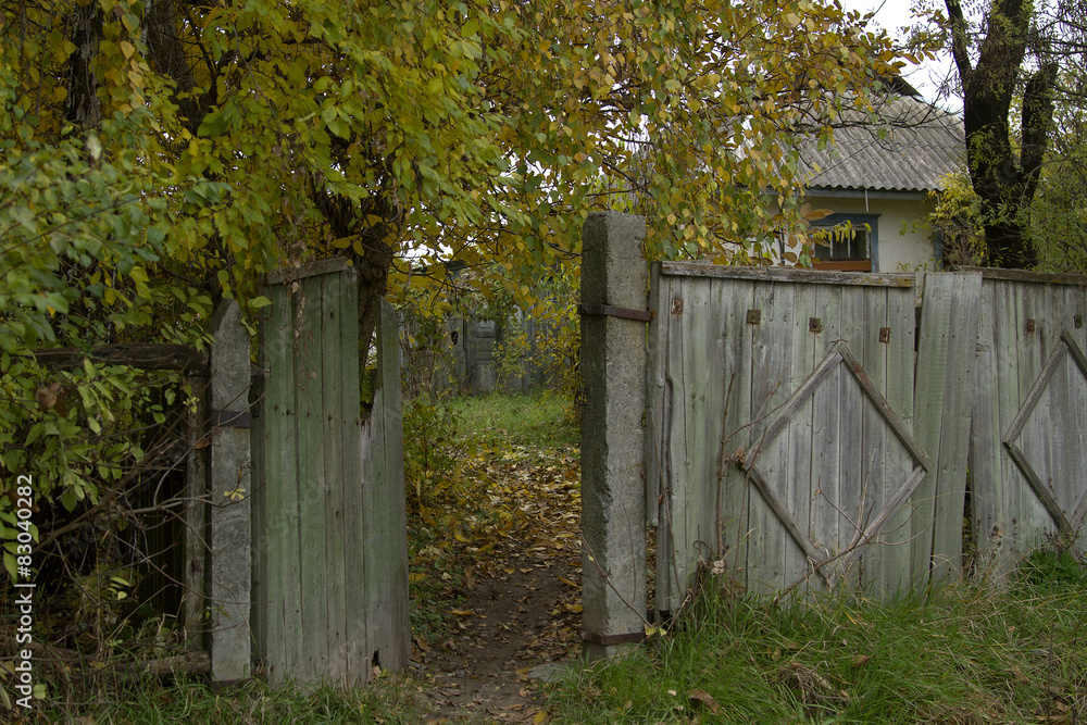 Naklejka premium rural fence, Abandoned house in autumn