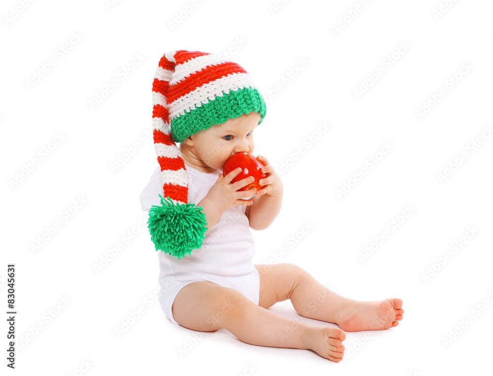 Christmas and childhood concept - baby in bright knitted gnome h Christmas and childhood concept - baby in bright knitted gnome h