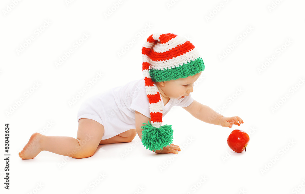 Christmas and childhood concept - baby in bright knitted gnome h Christmas and childhood concept - baby in bright knitted gnome h
