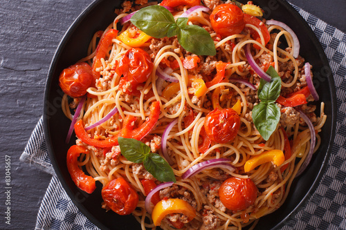 Delicious Italian spaghetti with vegetables macro, top view 