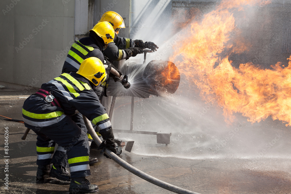 Fototapeta premium Firefighters attack a propane fire during a training exercise