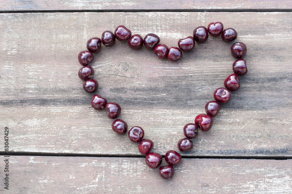 Cherry heart on wooden background Cherry heart on wooden background