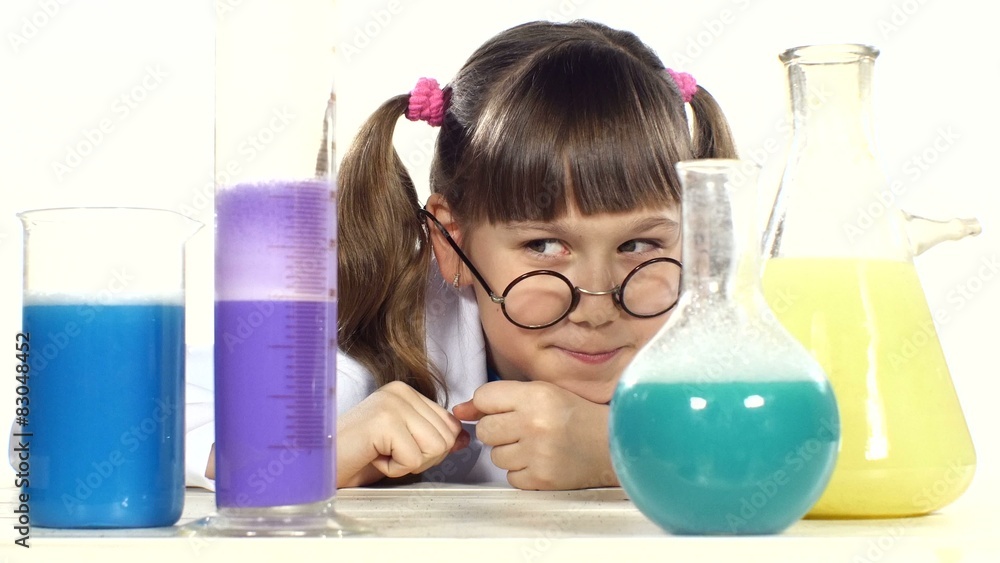Cute little girl with two ponytails in uniform, round glasses Cute little girl with two ponytails in uniform, round glasses