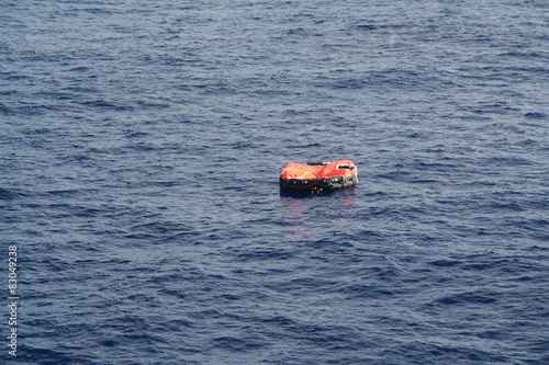 A life raft floats in mid ocean awaiting rescue