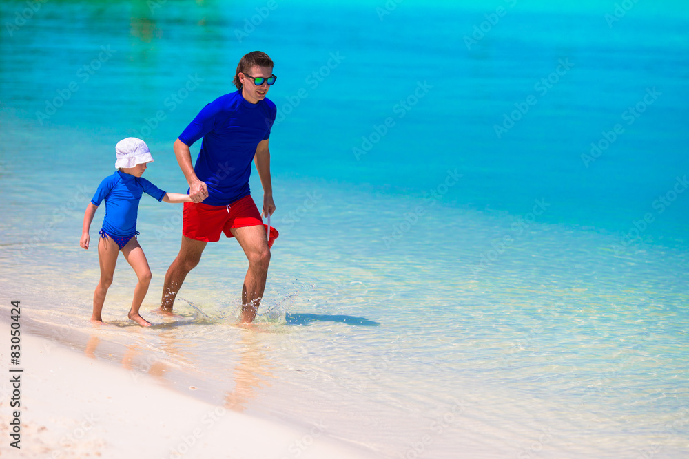 Little girl and young father during tropical beach vacation Little girl and young father during tropical beach vacation