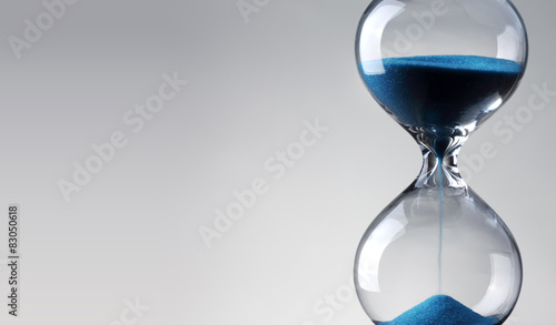 Time passing. Blue hourglass. photo