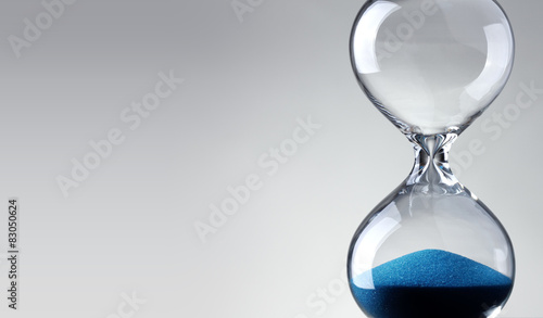 Time passing. Blue hourglass.