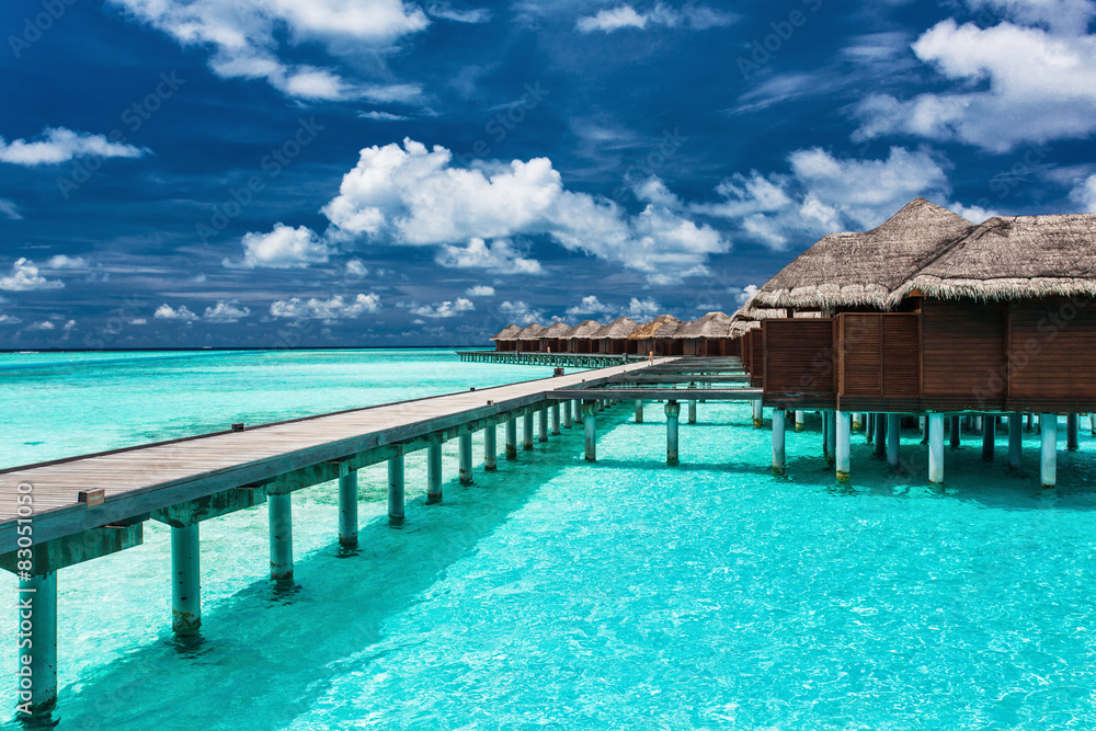 Overwater villas on the tropical lagoon with jetty
