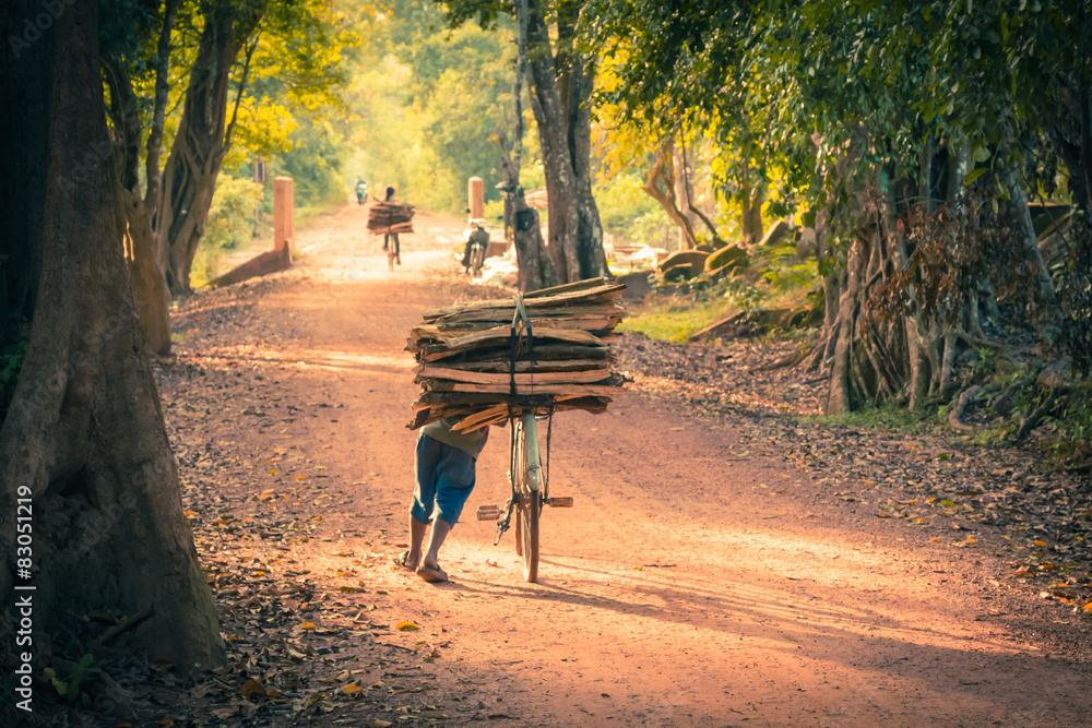 Cyclist on Dirt Road in the jungle. Cambodia